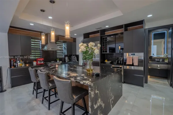 a kitchen with a table and chairs in it