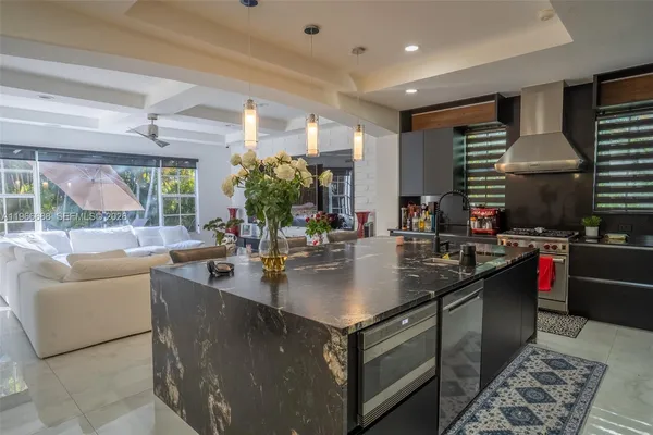 a kitchen with kitchen island granite countertop a sink and counter top space