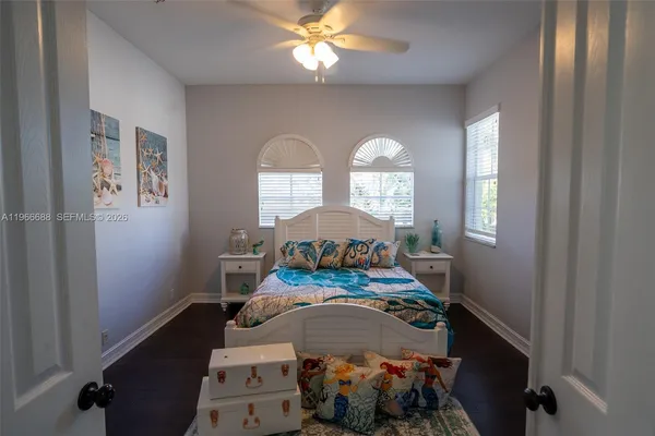 a bedroom with bed and a flat screen tv
