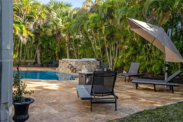 a view of a backyard with sitting area