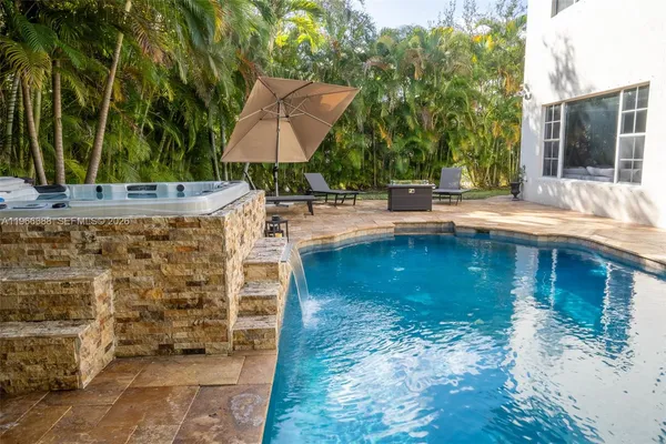 a view of a swimming pool with a patio