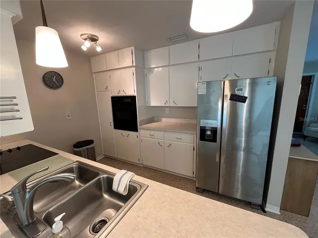 a kitchen with a refrigerator and a sink