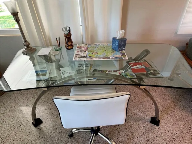 a living room with a rug and a table