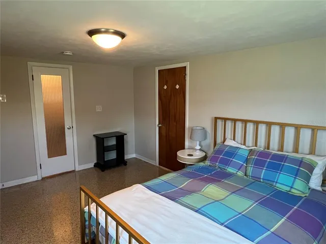 a bedroom with a bed and window