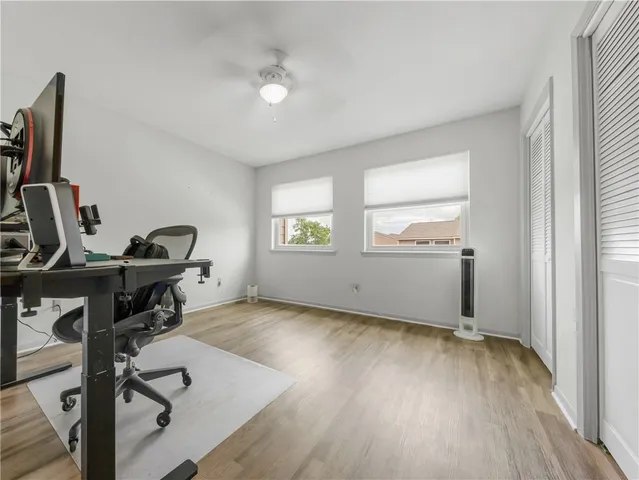 a view of a workspace with furniture and a window