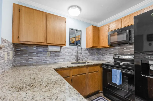 a kitchen with stainless steel appliances granite countertop a stove sink and cabinets