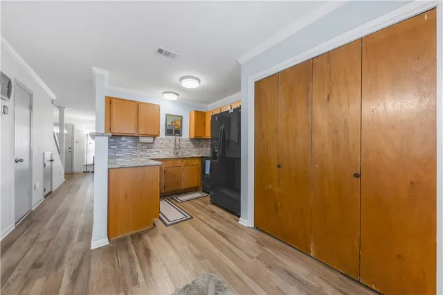 a kitchen with stainless steel appliances granite countertop a refrigerator and a stove top oven
