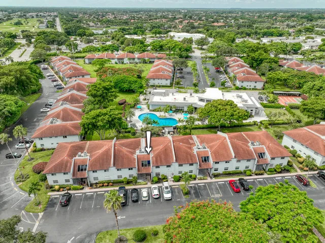 an aerial view of residential houses with outdoor space and parking