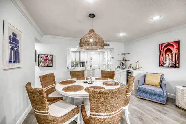 a dining room with furniture a rug and a chandelier