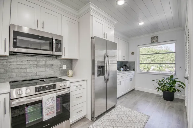 a kitchen with a stove microwave and refrigerator