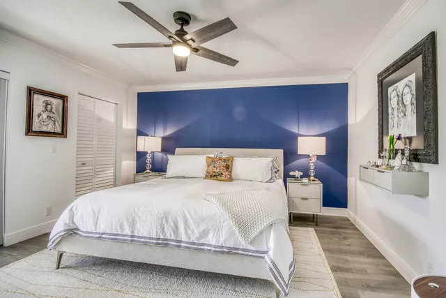 a bedroom with a large bed and a chandelier