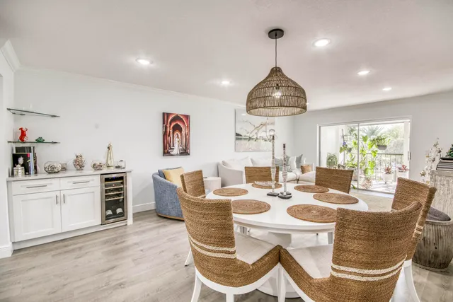 a dining room with furniture a chandelier and wooden floor