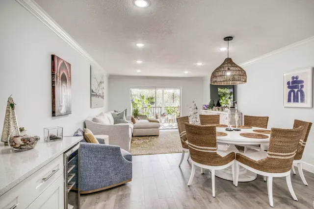 a living room with furniture a window and a dining table with wooden floor