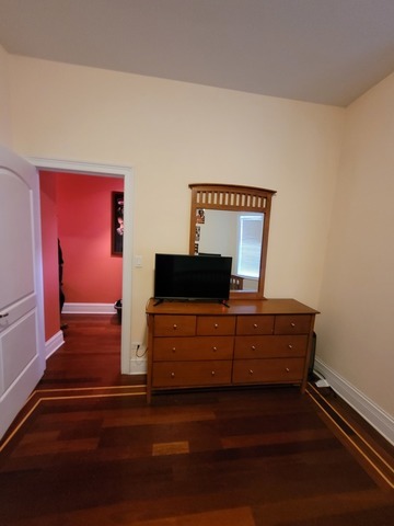 4546 South Indiana Avenue, Unit 2N Chicago, IL 60653 - Photo 13 of 16 a room with a bed and a window