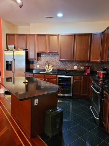 4546 South Indiana Avenue, Unit 2N Chicago, IL 60653 - Photo 4 of 16 a kitchen with kitchen island a sink stove and refrigerator