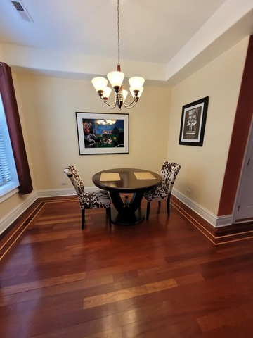 4546 South Indiana Avenue, Unit 2N Chicago, IL 60653 - Photo 7 of 16 a view of a dining room with furniture and a chandelier