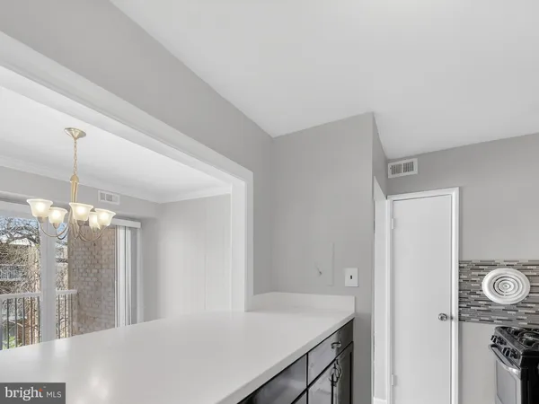 a view of a kitchen from the hallway