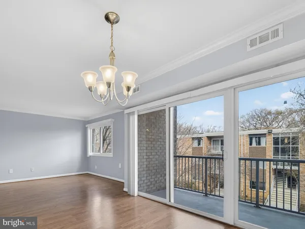 a view of a room with wooden floor and windows