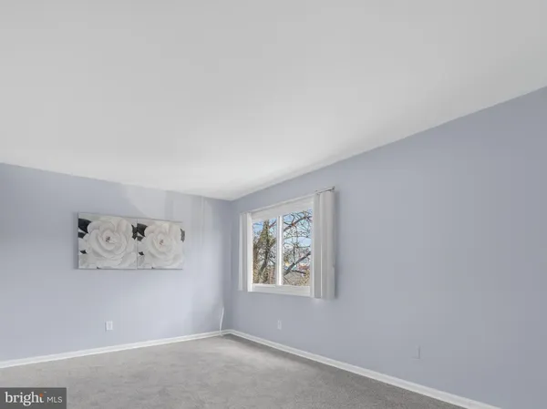 an empty room with wall painting and a window
