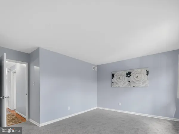 an empty room with painting on the wall