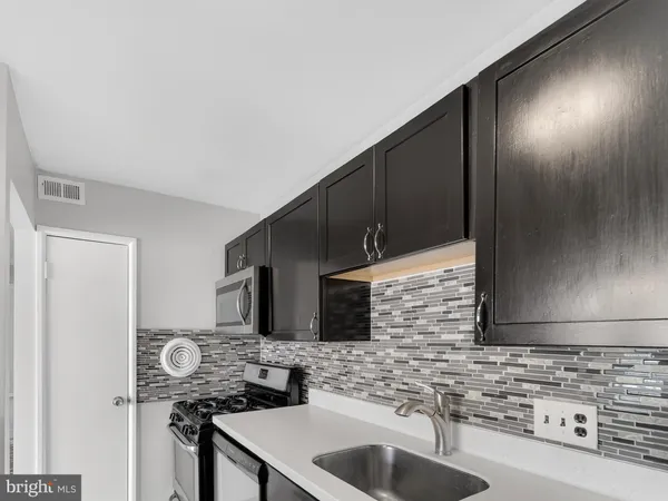a kitchen with stainless steel appliances granite countertop a sink and cabinets