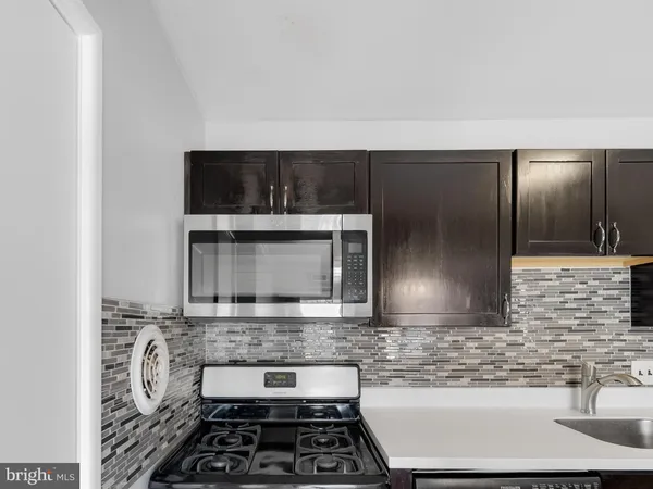 a kitchen with sink and cabinets