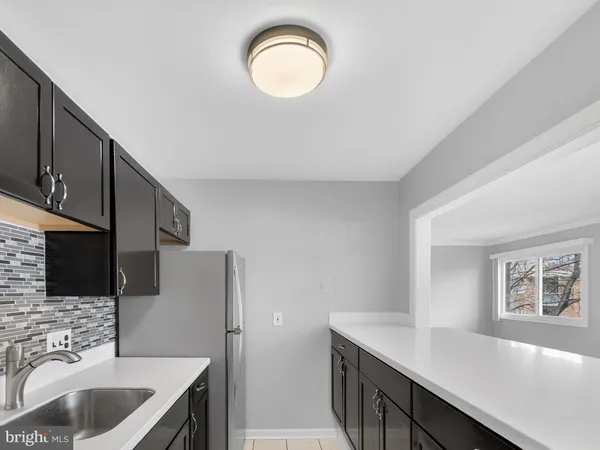 a kitchen with a sink cabinets and appliances