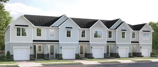 a view of a big house with wooden fence