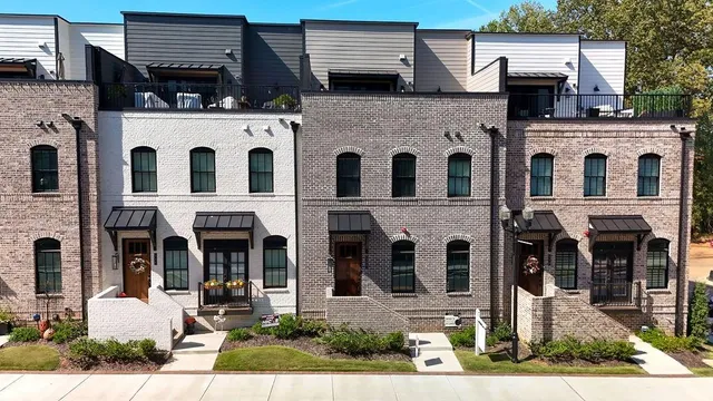 a front view of a residential apartment building with a yard