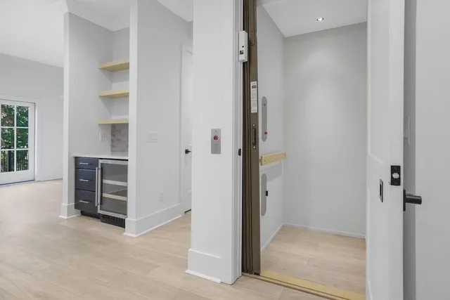 a bedroom with bed and a chandelier