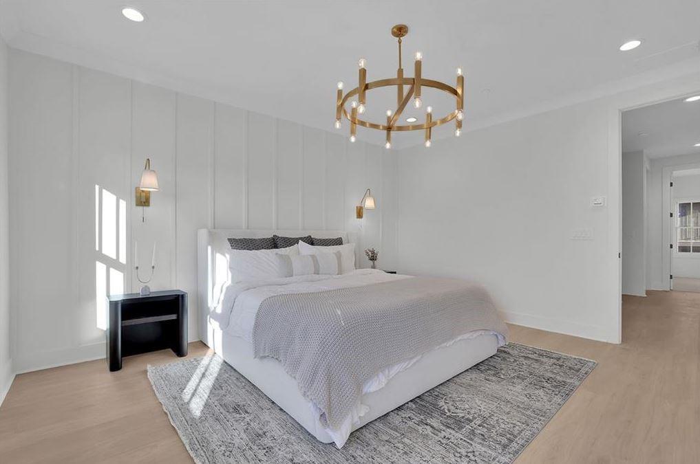 332 Sugarview Road, Unit 16 Sugar Hill, GA 30518 - Photo 14 of 31 a bedroom with bed and a chandelier