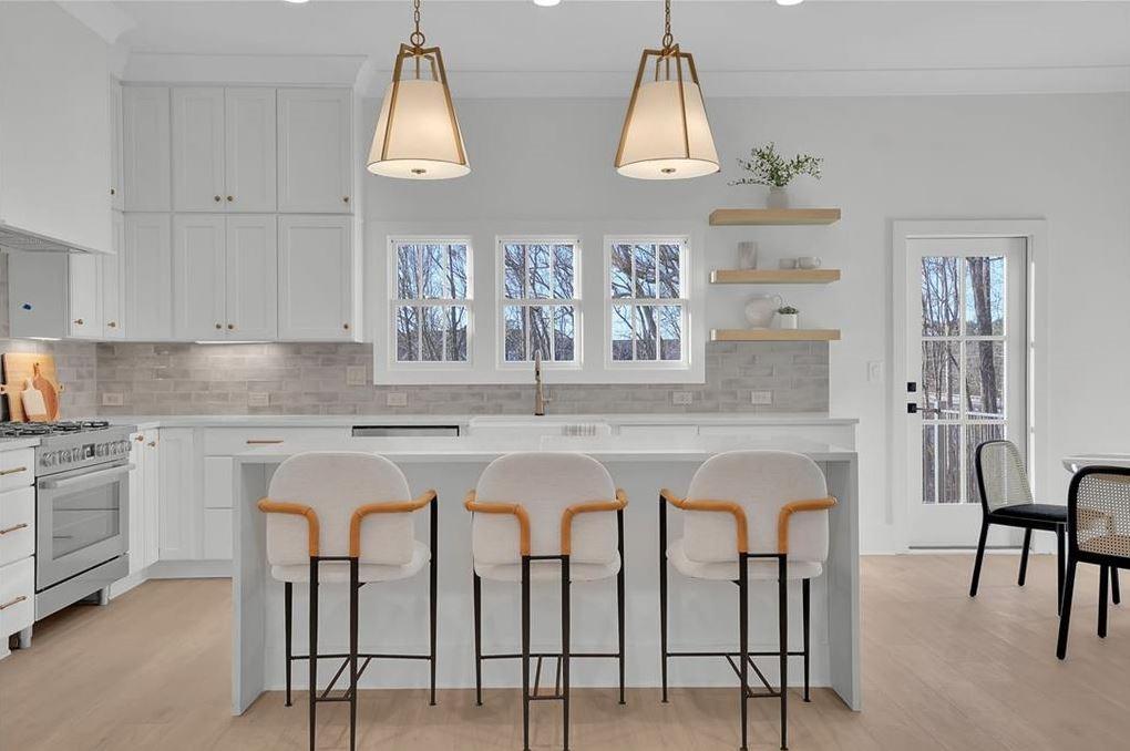 332 Sugarview Road, Unit 16 Sugar Hill, GA 30518 - Photo 2 of 31 a kitchen with stainless steel appliances granite countertop a table chairs sink and cabinets