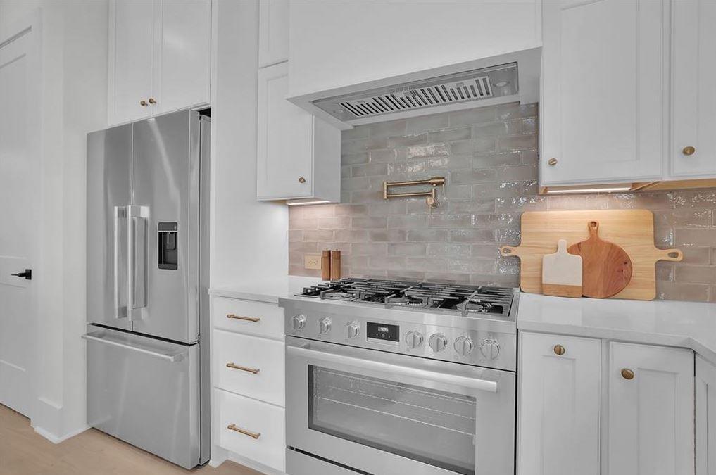 332 Sugarview Road, Unit 16 Sugar Hill, GA 30518 - Photo 4 of 31 a kitchen with stainless steel appliances white cabinets and white appliances