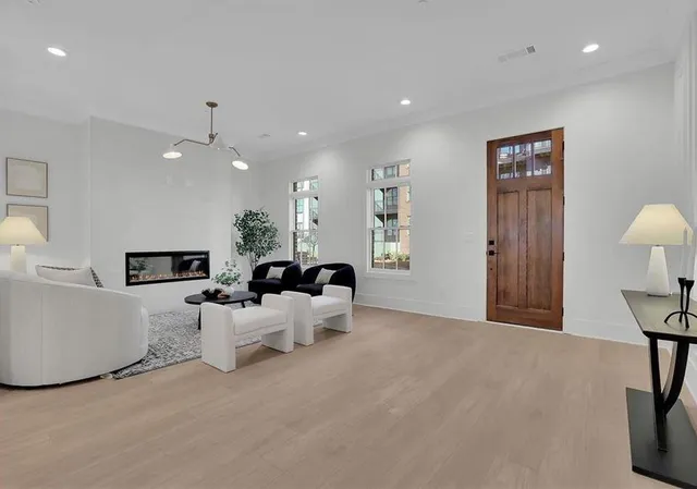 a living room with furniture a chandelier and a flat screen tv