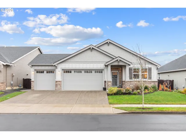 a view of a house with a big yard and large trees
