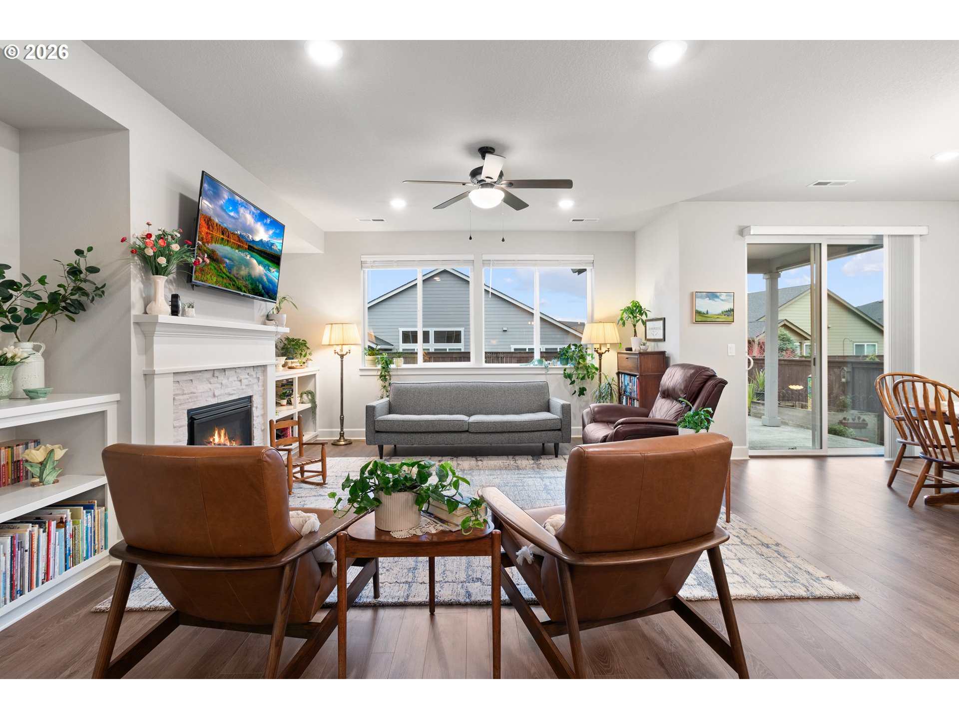 4935 South 16th Drive Ridgefield, WA 98642 - Photo 11 of 47 a living room with furniture a flat screen tv and a fireplace