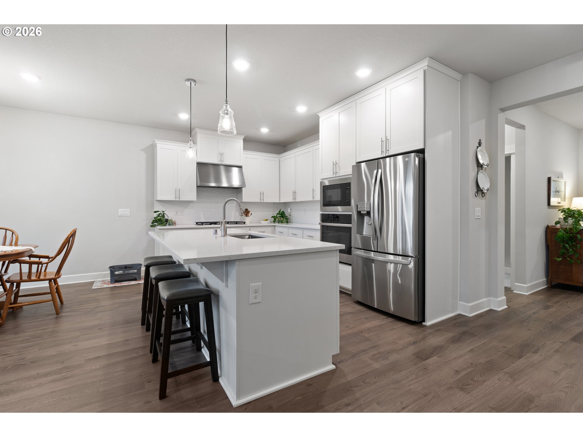 4935 South 16th Drive Ridgefield, WA 98642 - Photo 15 of 47 a kitchen with refrigerator a sink and chairs