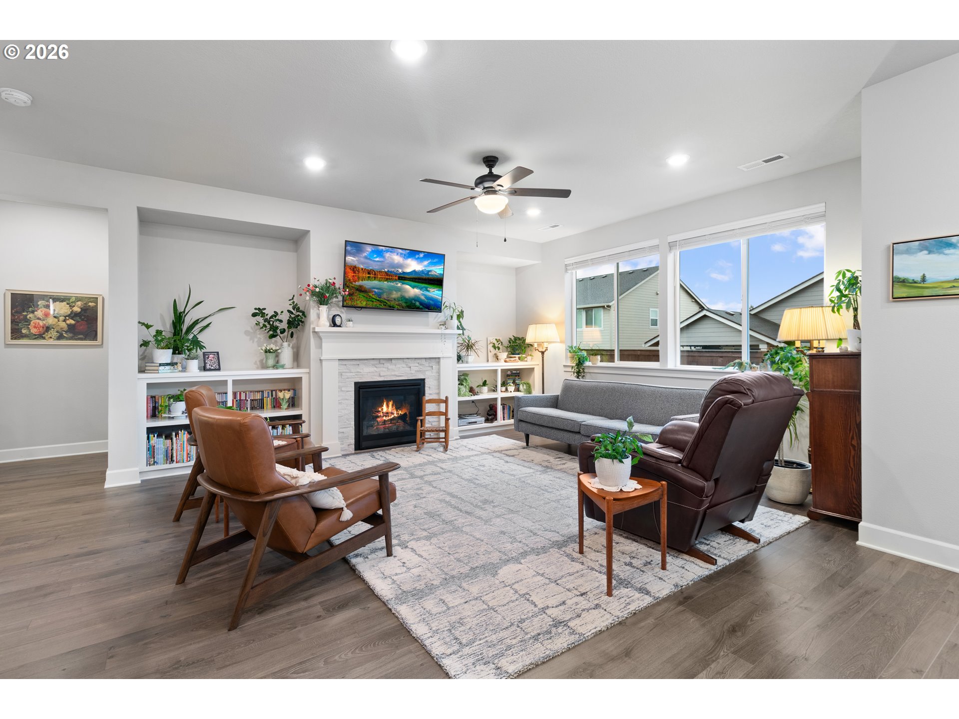4935 South 16th Drive Ridgefield, WA 98642 - Photo 8 of 47 a living room with furniture a fireplace and a flat screen tv