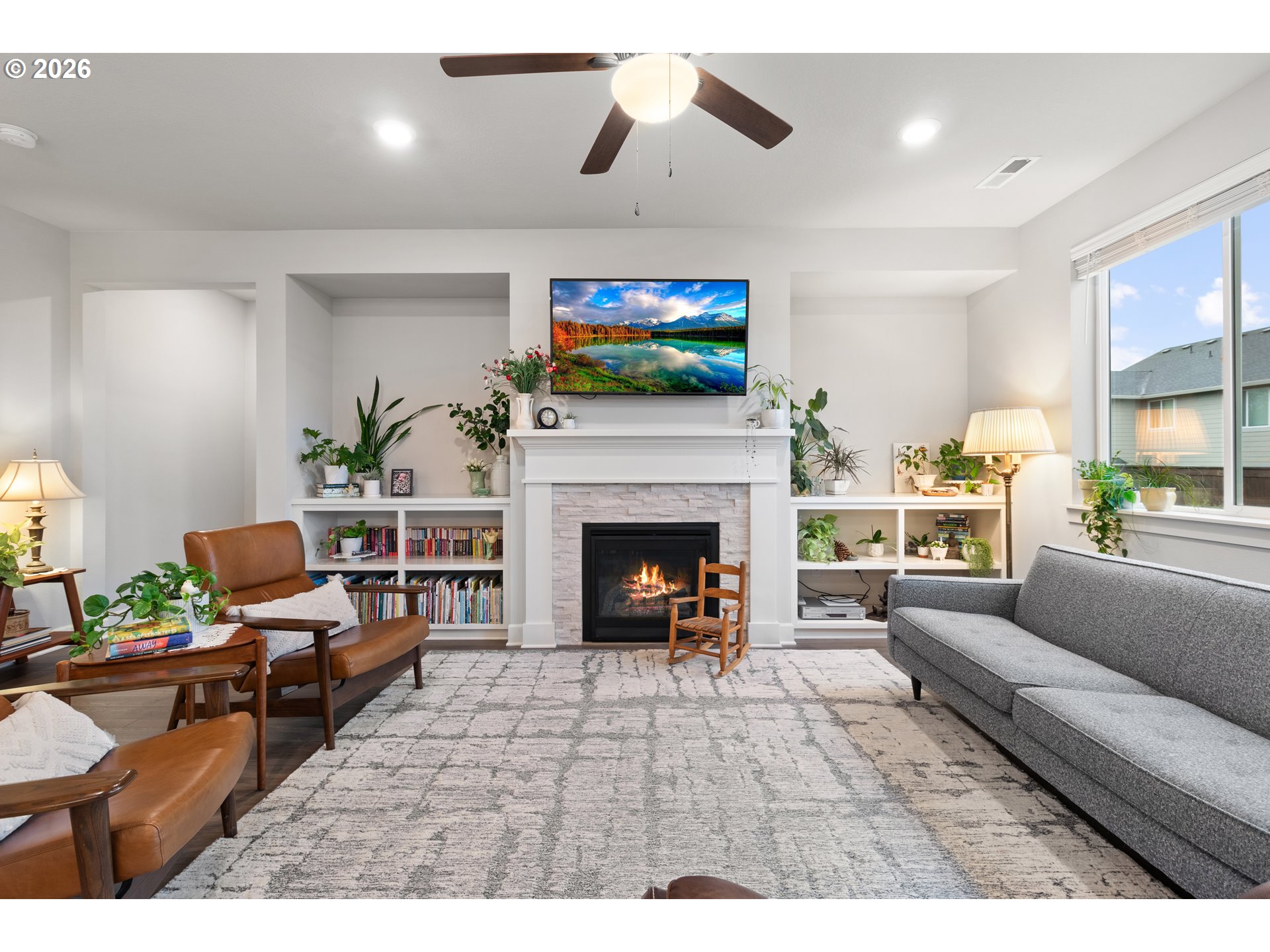 4935 South 16th Drive Ridgefield, WA 98642 - Photo 9 of 47 a living room with furniture a flat screen tv and a fireplace