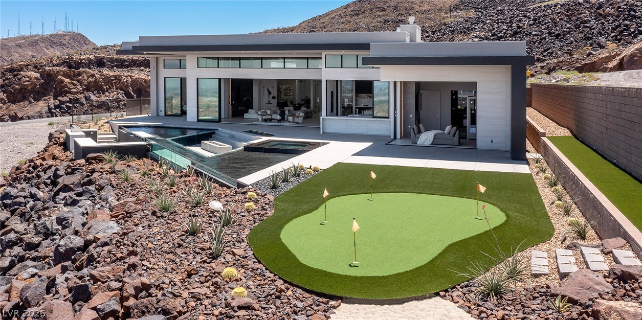 563 Grand Rim Drive Henderson, NV 89012 - Photo 60 of 70 An inviting putting green and private pool deck complement this desert oasis home.