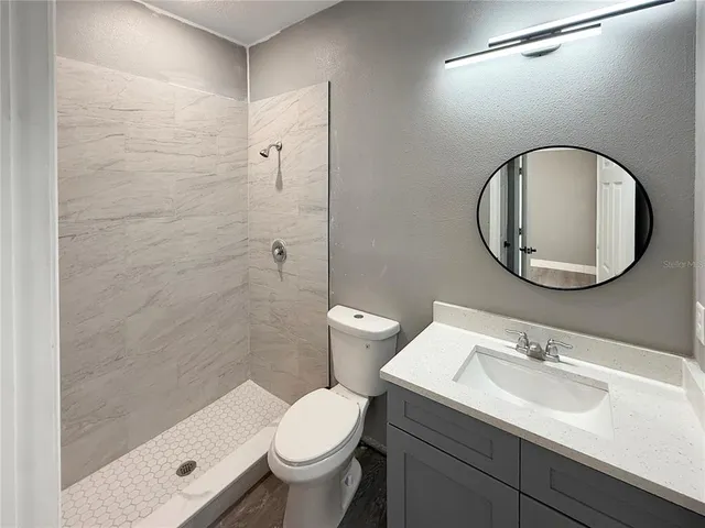 a bathroom with a sink toilet and a mirror