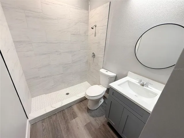 a bathroom with a toilet a sink and a mirror