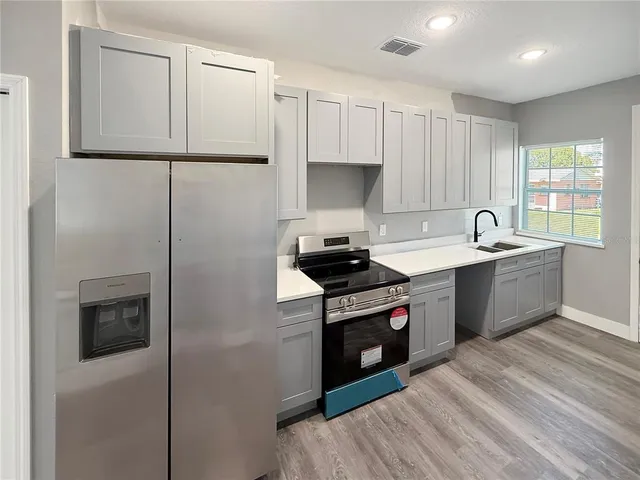a kitchen with a sink stove and refrigerator