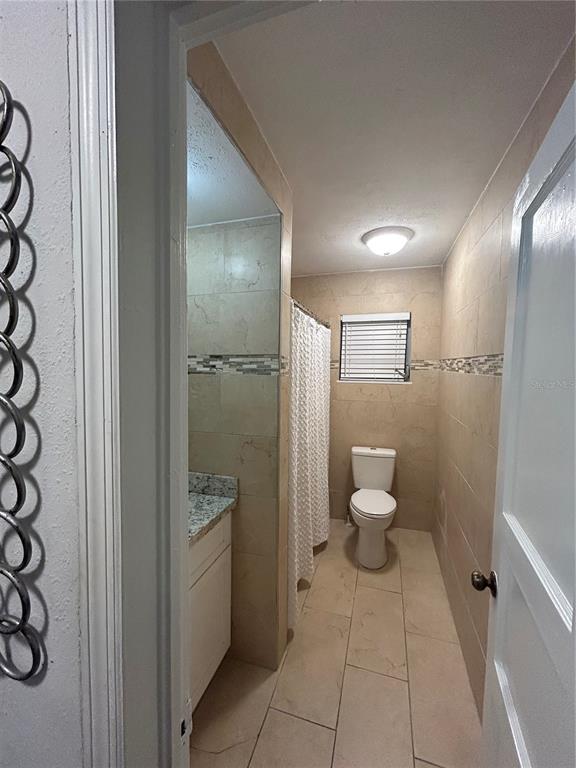 48 East Par Street Orlando, FL 32804 - Photo 15 of 25 a bathroom with a granite countertop toilet and a shower