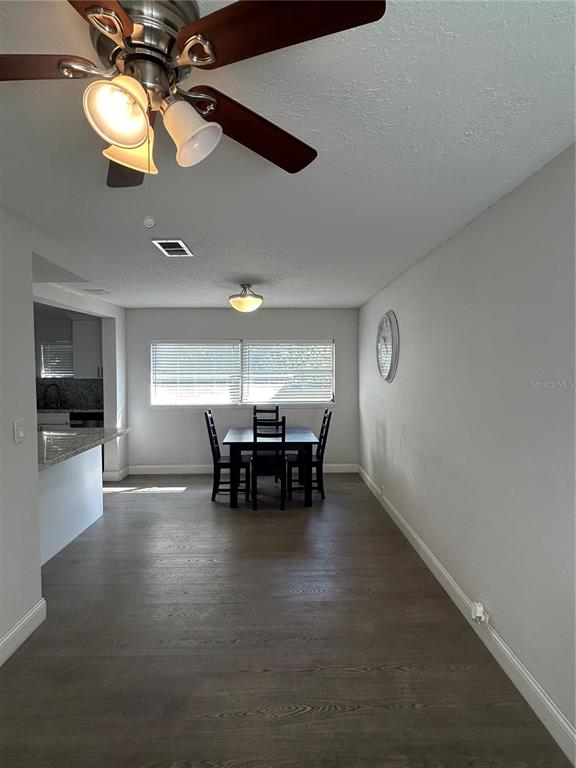 48 East Par Street Orlando, FL 32804 - Photo 17 of 25 a view of dining room and kitchen with furniture and a ceiling fan