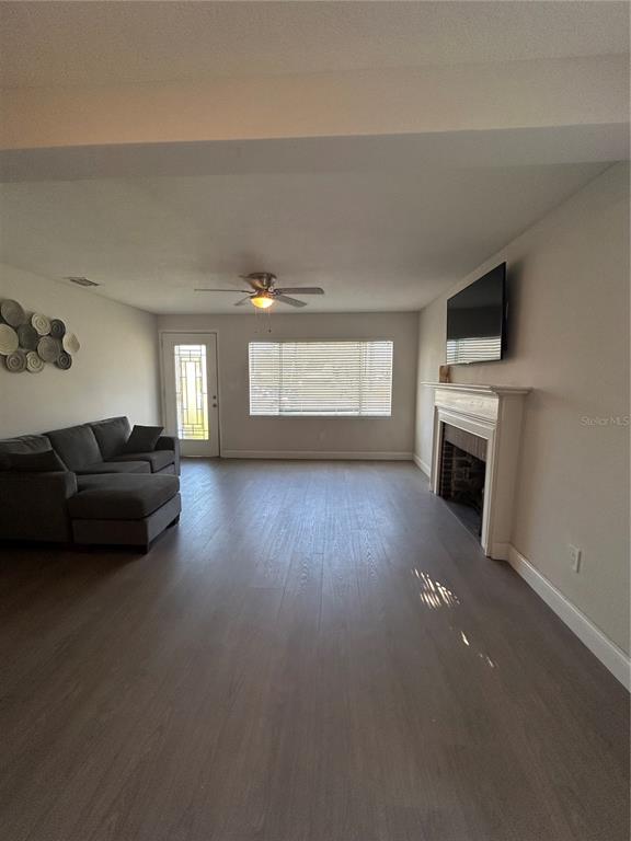 48 East Par Street Orlando, FL 32804 - Photo 9 of 25 a living room with furniture a fireplace and a flat screen tv