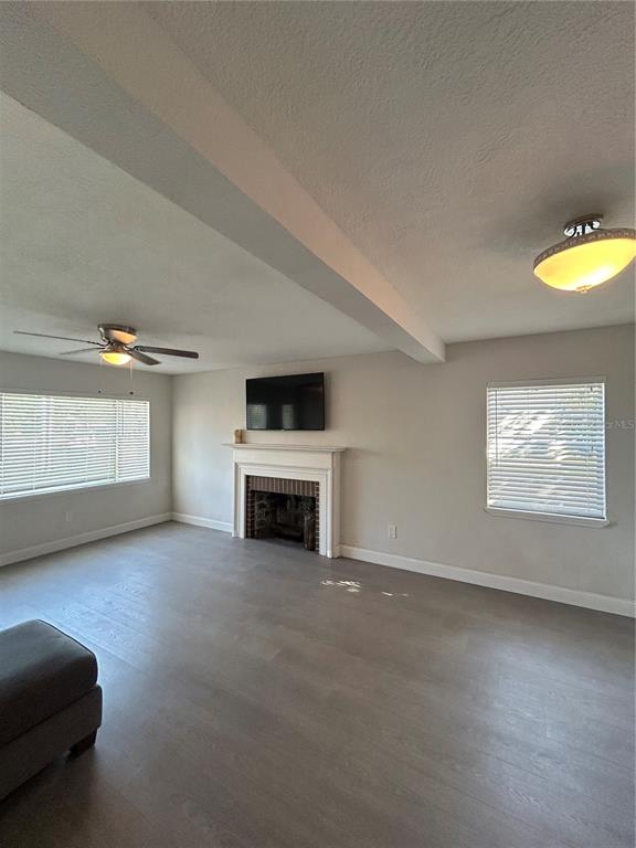 48 East Par Street Orlando, FL 32804 - Photo 10 of 25 a view of a livingroom with a fireplace a window and a couch