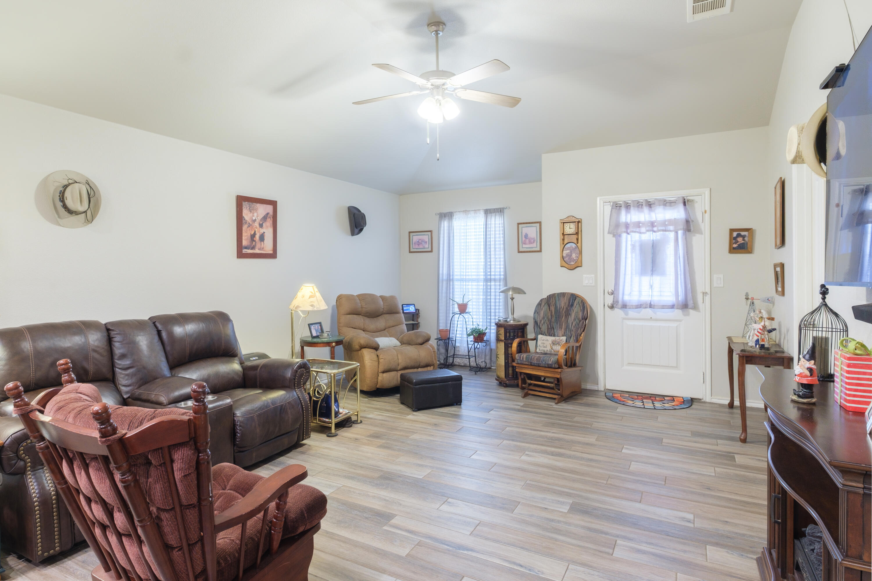 6821 39th Street Lubbock, TX 79407 - Photo 3 of 25 a living room with furniture and a wooden floor