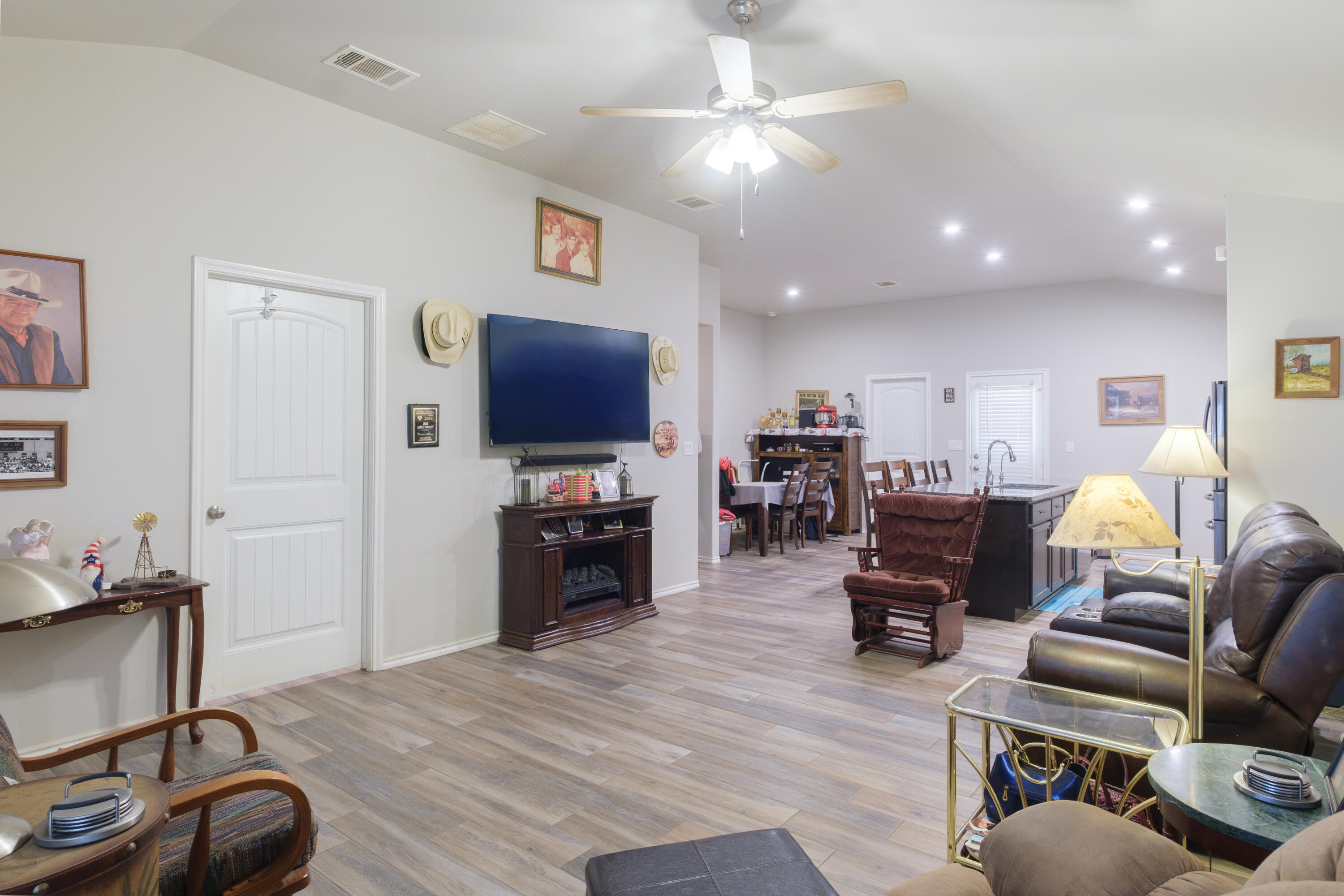 6821 39th Street Lubbock, TX 79407 - Photo 4 of 25 a living room with furniture and a flat screen tv