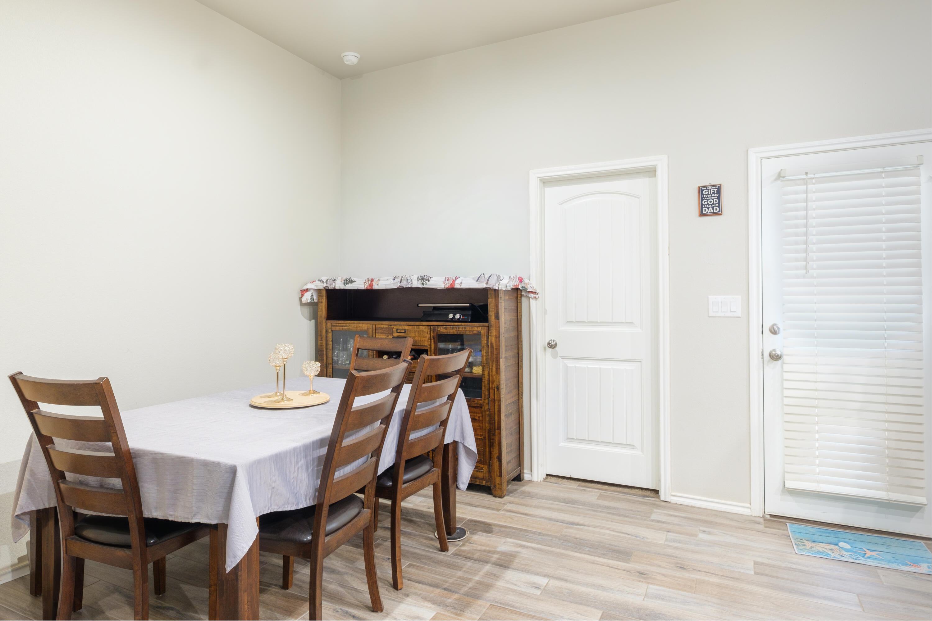 6821 39th Street Lubbock, TX 79407 - Photo 8 of 25 a view of a dining room with furniture and wooden floor